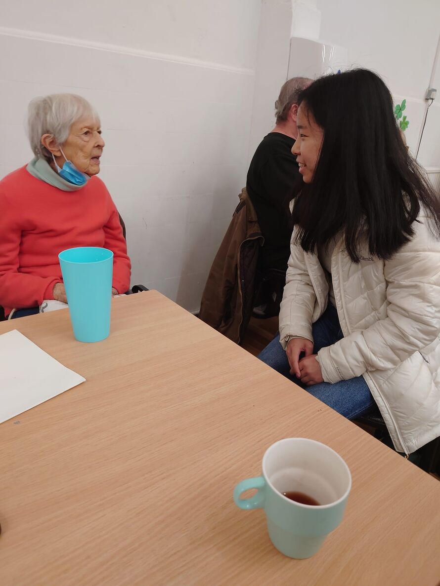 Yi Lin at coffee morning with an attendee