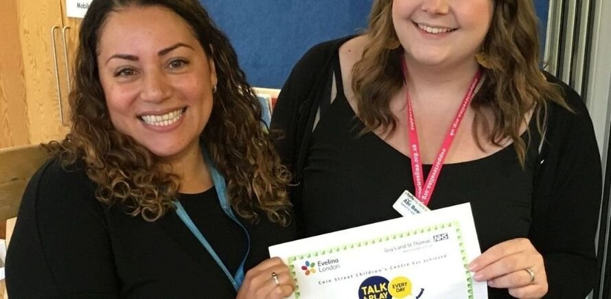 Claudia, pictured left, receiving an award from Evelina London