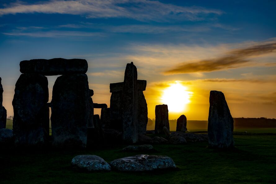 An image of Stonehenge with the sun setting.