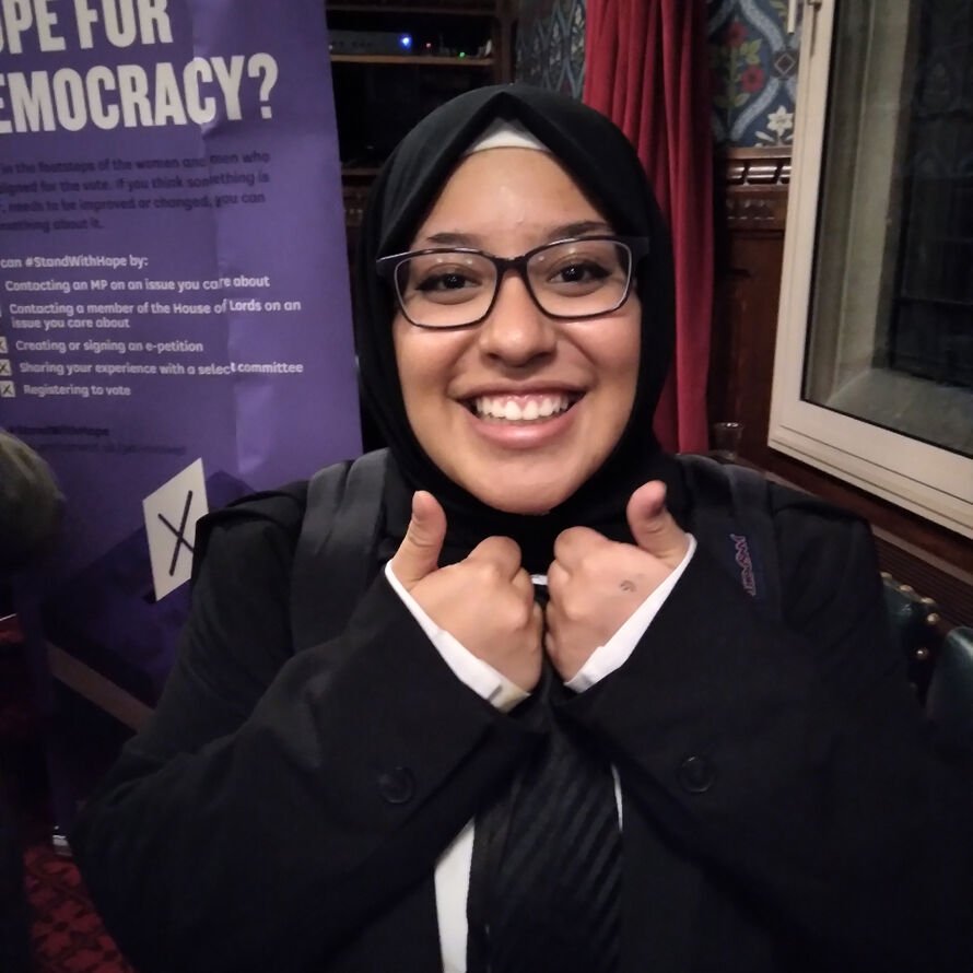 Iman smiling with her thumbs up