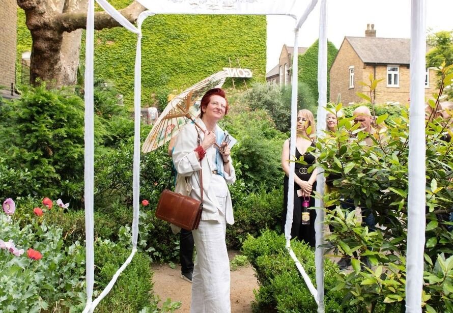 Woman enjoying outdoor art display in st johns coutyard gardens